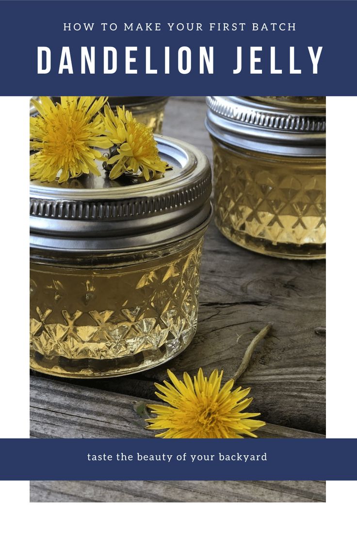 two jars filled with yellow flowers sitting on top of a wooden table next to each other