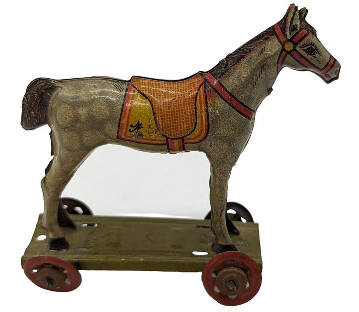 This vintage Germany tin litho platform horse penny toy is a unique collectible that is perfect for toy enthusiasts. The horse is a gray dapple with wheels and is made of tin. It was manufactured in approximately the 1930s in Germany, making it a vintage toy. This toy is sure to be a great addition to any collection. Condition is pre-owned and good, but with some damage to the left rear leg. Please review all photos before purchase as there are no returns. Ships with USPS Ground Advantage. Vintage Toy Display, Curiosity Cabinet, Vintage Germany, Toy Display, Metal Lunch Box, Unique Collectibles, Tin Toys, Antique Toys, Old Toys