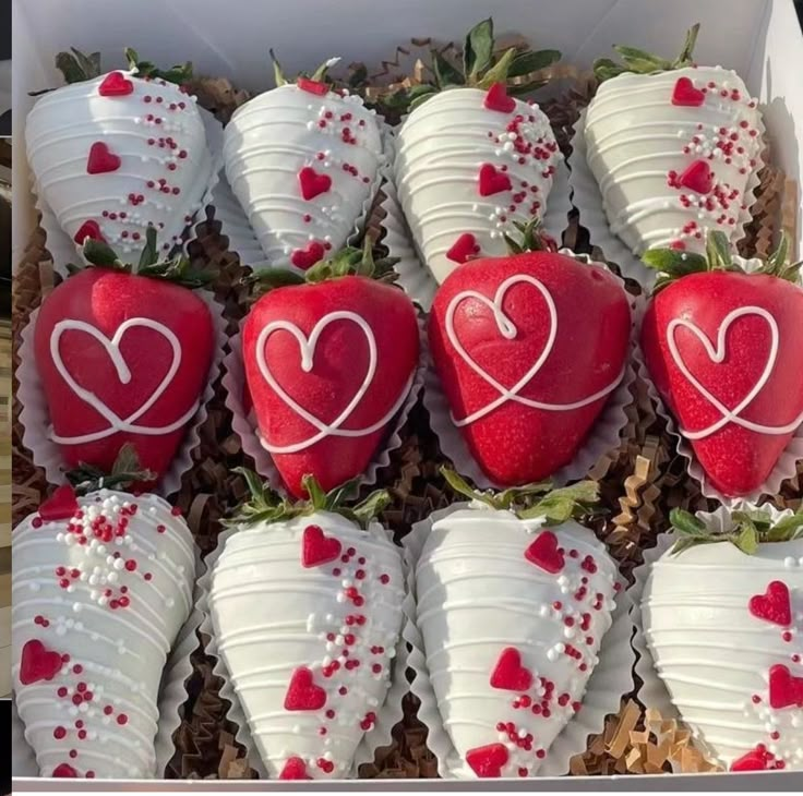 a box filled with chocolate covered strawberries in the shape of hearts