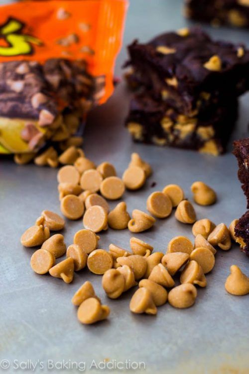 chocolate and peanut butter bars are on a counter next to a bag of candy chips