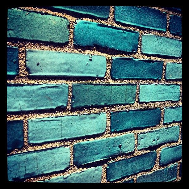 a brick wall with blue paint on it