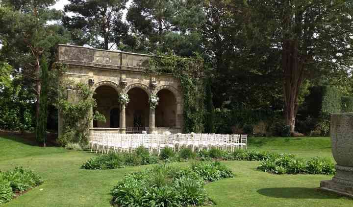 an outdoor ceremony setup in the middle of a garden