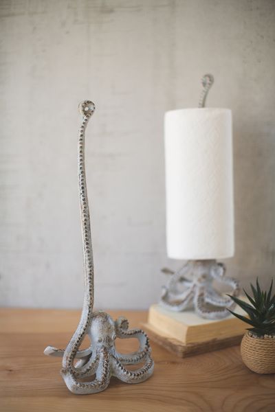 an octopus lamp sitting on top of a wooden table next to a potted plant