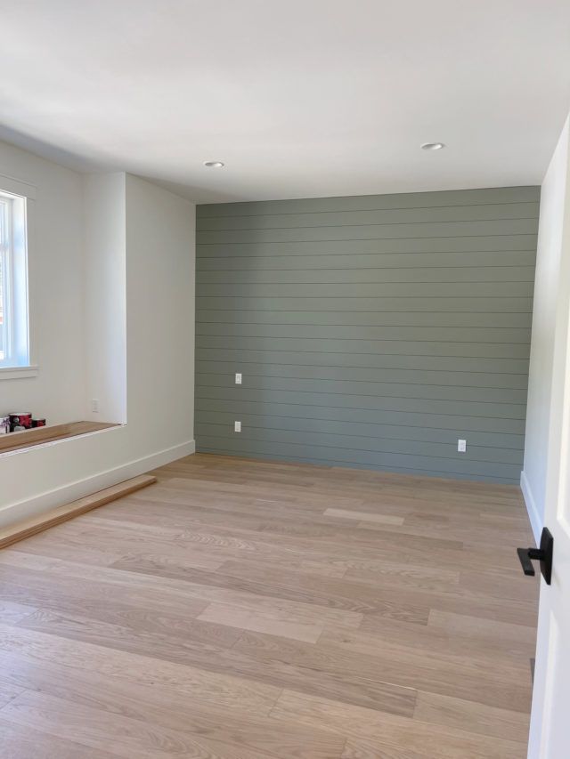 an empty room with hard wood floors and white paint on the walls is seen in this image