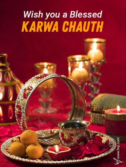 a couple of candles sitting on top of a plate next to each other with the words, wish you a blessing karwa chauth