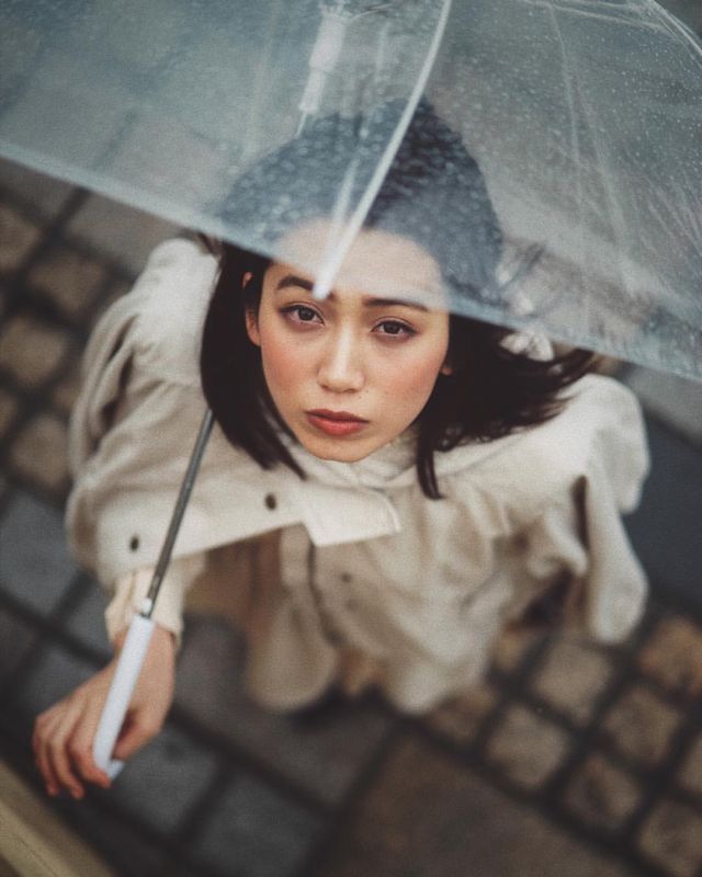 a woman holding an umbrella over her head