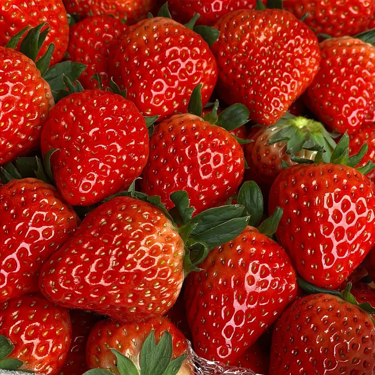 a pile of red strawberries sitting on top of each other