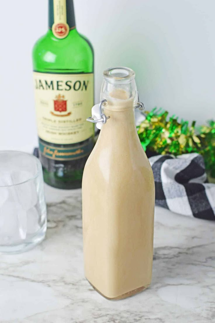 an empty bottle sitting on top of a marble counter