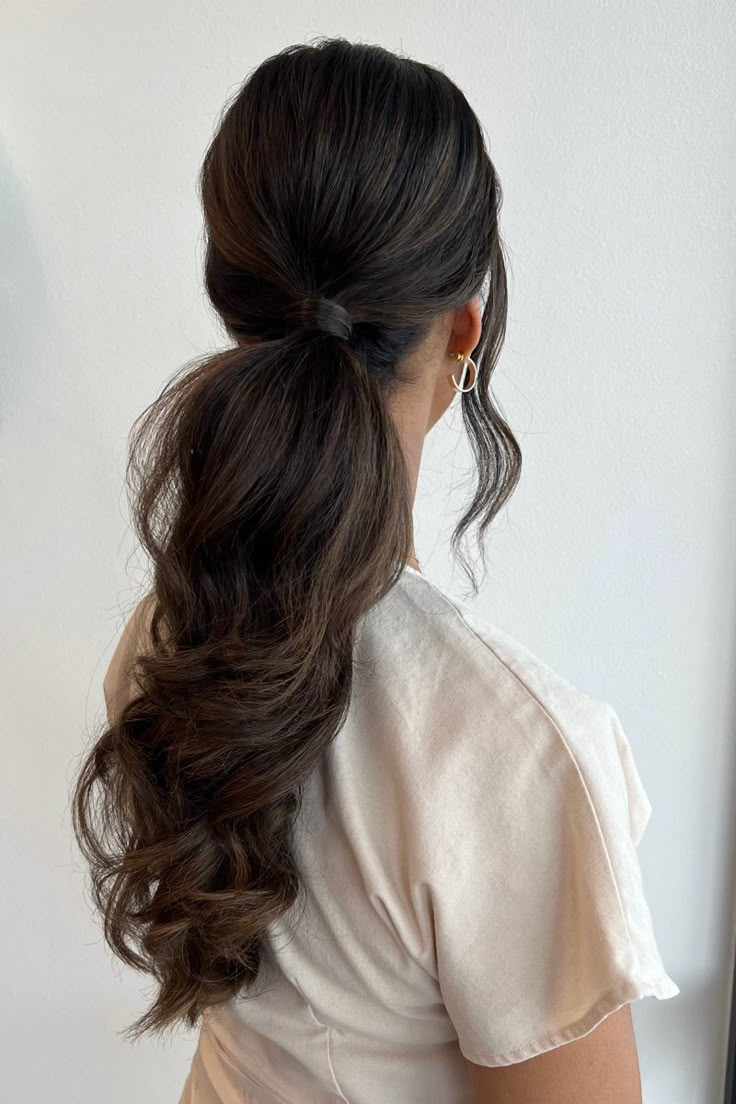 a woman with long hair in a ponytail