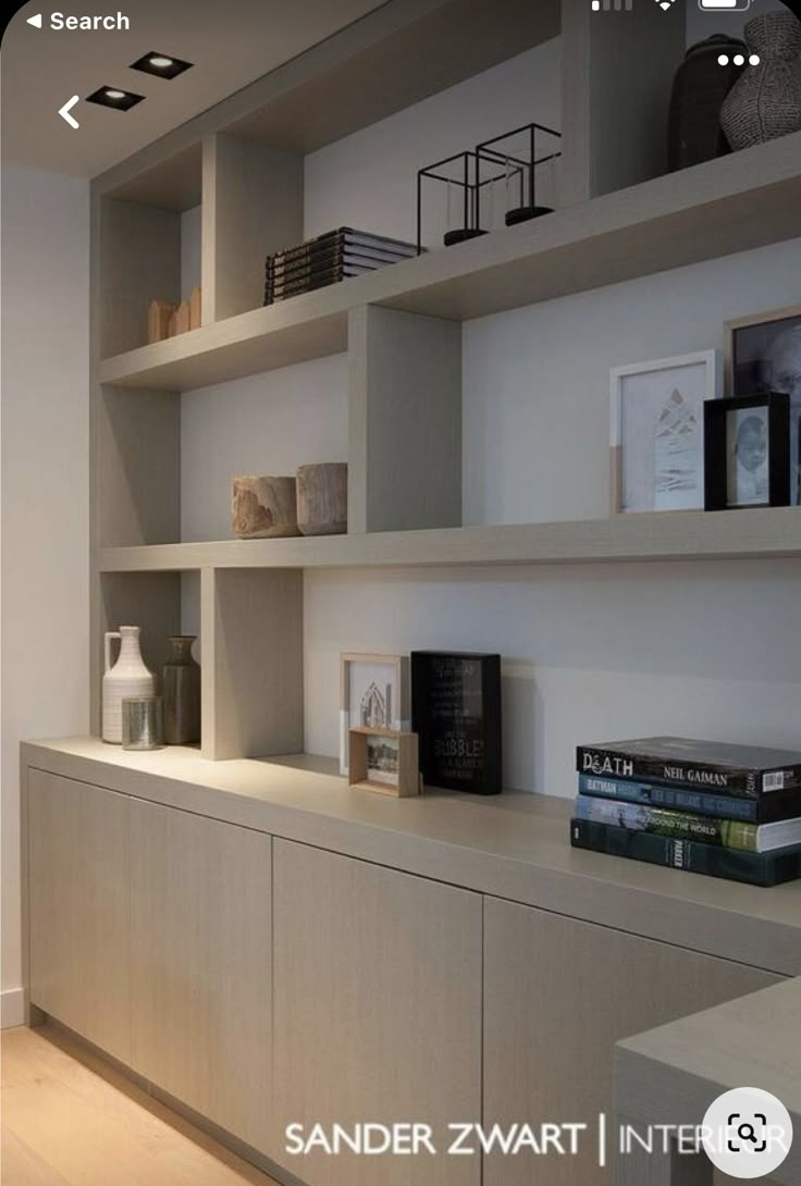 an image of a room with shelves and books on the shelf in front of it