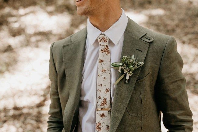 a man in a suit with a flower on his lapel