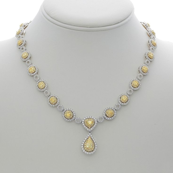 Navigate the nuances of elegance with our Hanging Pear Two Tone Diamond Necklace. Crafted for the soulful romantic in you, this necklace embodies the perfect blend of sophistication and allure. Picture this: glistening white and yellow diamonds, totaling a mesmerizing 13.12 carats, grace the entire neckline of this exquisite 18K gold masterpiece. Amidst the cascade of diamonds, a resplendent pear-shaped yellow diamond steals the spotlight, casting a warm glow that captures the heart.Imagine adorning yourself with this necklace, the embodiment of timeless love and captivating grace. The pear-shaped yellow diamond, delicately prong-set, hangs gracefully from the center, embraced by a halo of dazzling white diamonds. Each facet of this pendant tells a story, a tale of love and passion that li Elegant Teardrop Fine Jewelry Necklace, Teardrop Fine Jewelry Necklace With Elegant Design, Fine Jewelry Teardrop Necklace With Elegant Design, Teardrop Necklace With Elegant Design In Fine Jewelry Style, Teardrop Shaped Fine Jewelry Necklace With Elegant Design, Luxury White Teardrop Pendant Necklace, Exquisite Pear-shaped Necklace For Anniversary, Exquisite Pear-shaped Anniversary Necklace, Luxury Teardrop Necklace With Elegant Design