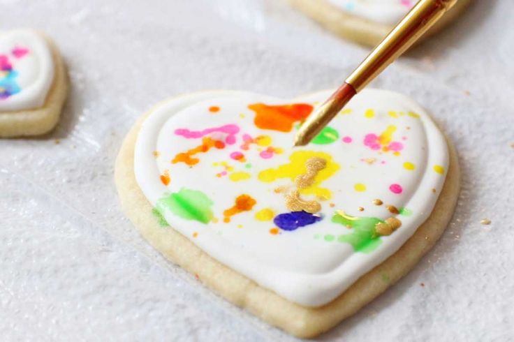 some cookies with icing and paint on them