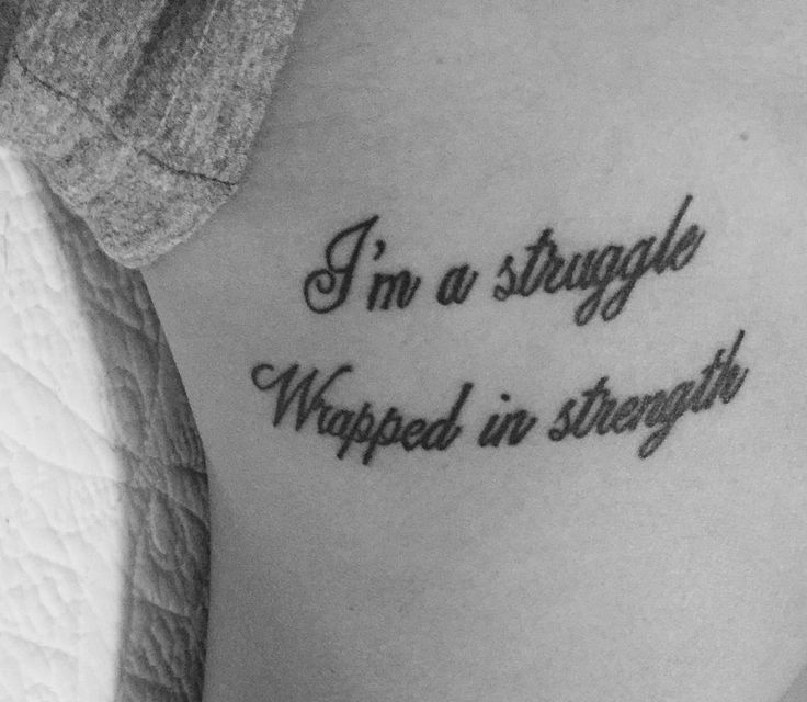 a woman with a tattoo saying i'm a struggle wrapped in strength on her stomach