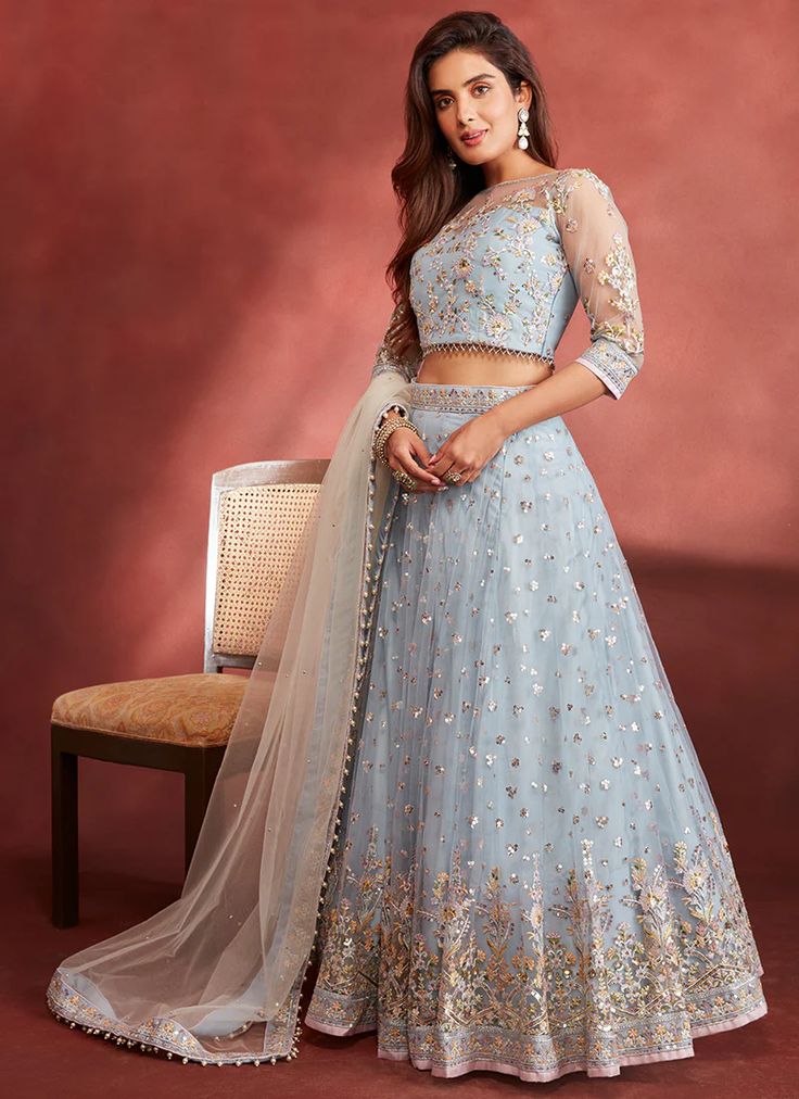 Dusty Blue Embroidered Net Lehenga features a net blouse and lehenga with santoon inner alongside a net dupatta. Zari, thread and stone embellishments are used for the embroidery of this style.  Like all of our pieces, this piece is made in India and checked by hand to ensure high quality.