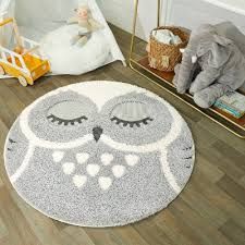 an owl rug on the floor in a child's room