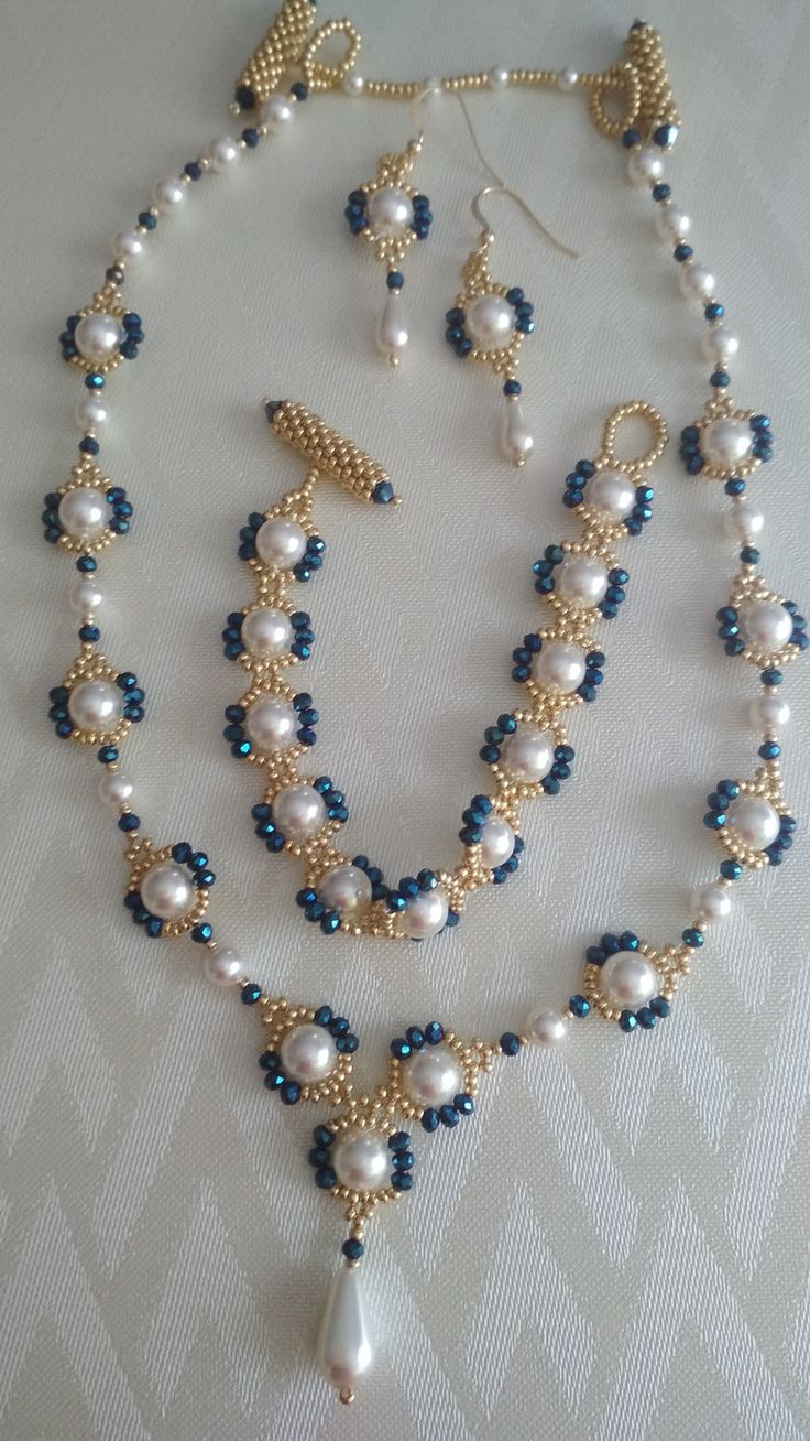 a blue and white beaded necklace with matching earrings