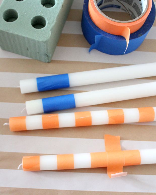 three orange and white striped straws next to a tape dispenser