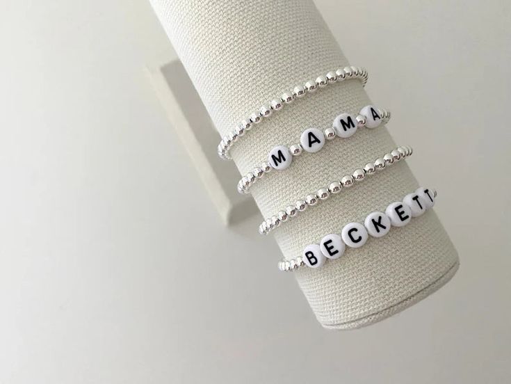 one name bracelet made with 4mm sterling silver beads bracelets are made on a durable stretch elastic cord please refer to our sizing guide before purchasing Classic White Beaded Bracelets As Gift, Classic White Beaded Bracelets For Gift, White Adjustable Classic Stretch Bracelet, White Classic Adjustable Stretch Bracelet, White Stretch Bracelet With Letter Beads For Birthday, Elegant White Name Bracelet With Letter Beads, Classic White Name Bracelet As Gift, White Stackable Stretch Bracelet For Birthday, White Round Beads Stretch Bracelet For Birthday