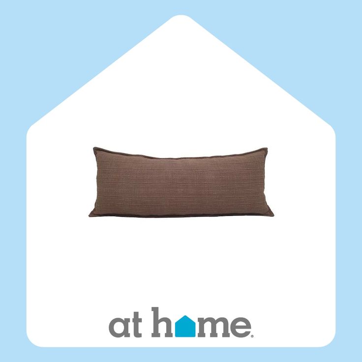 a brown pillow sitting on top of a blue and white background with the words at home