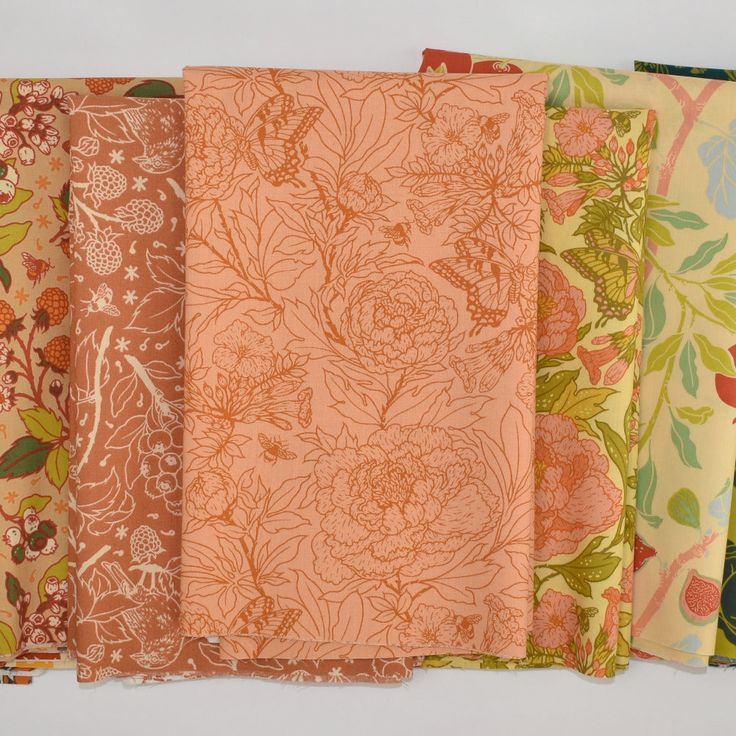 six different colors of fabric with flowers and leaves on them, all lined up in rows