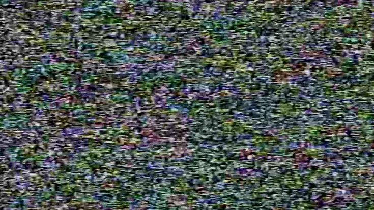 an old television screen is covered in green and purple speckles, as if it were taken from above