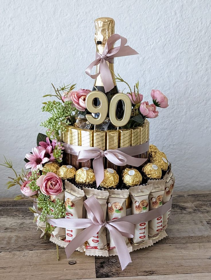 a cake made out of chocolates and flowers with the number 90 on it's top