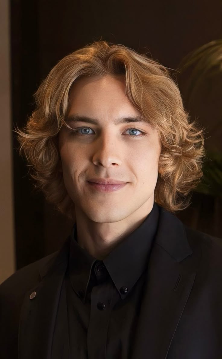 a close up of a person wearing a black shirt and suit with blonde hair smiling at the camera