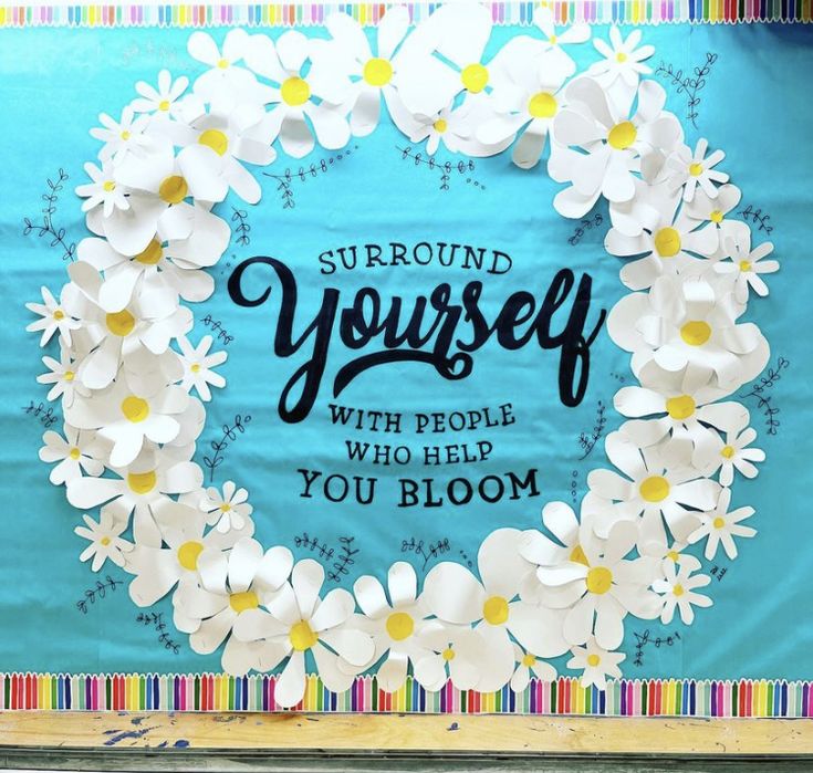 a paper flower wreath with the words surround yourself, with people who help you bloom