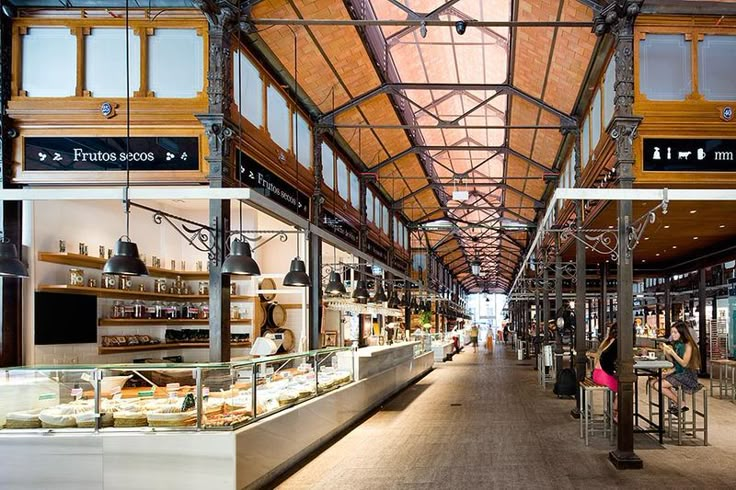 the inside of a restaurant with lots of counter space and food on display in it