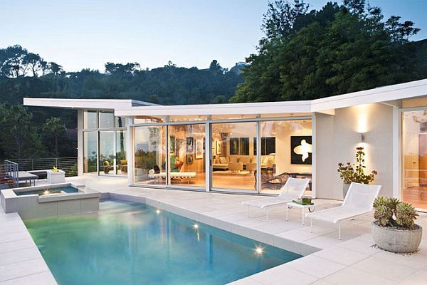 a modern house with a swimming pool in the backyard