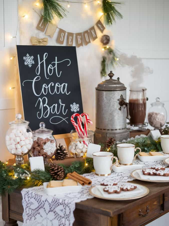 a table set up with hot cocoa bar and candy canes, marshmallows