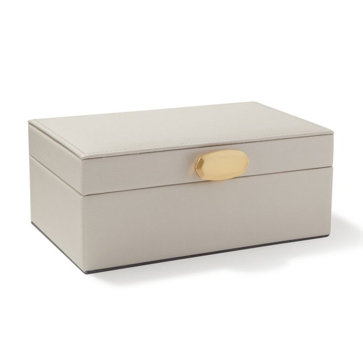 a white box with a gold handle on the lid is shown in front of a white background