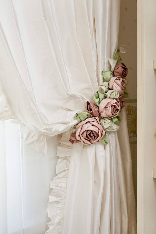 an image of flowers on the curtain in front of a window with white curtains and pink roses attached to it