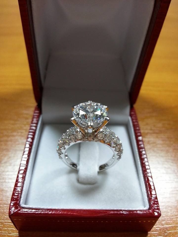 a diamond ring in a red box on a table