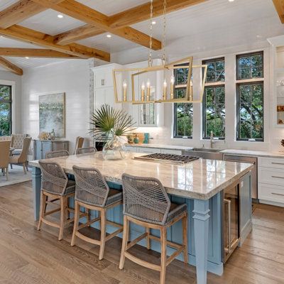 a large kitchen with an island in the middle and lots of counter space on one side