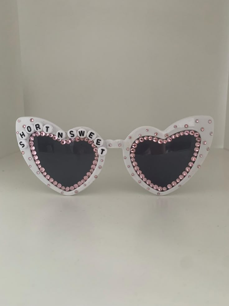 a pair of sunglasses with hearts and words on them