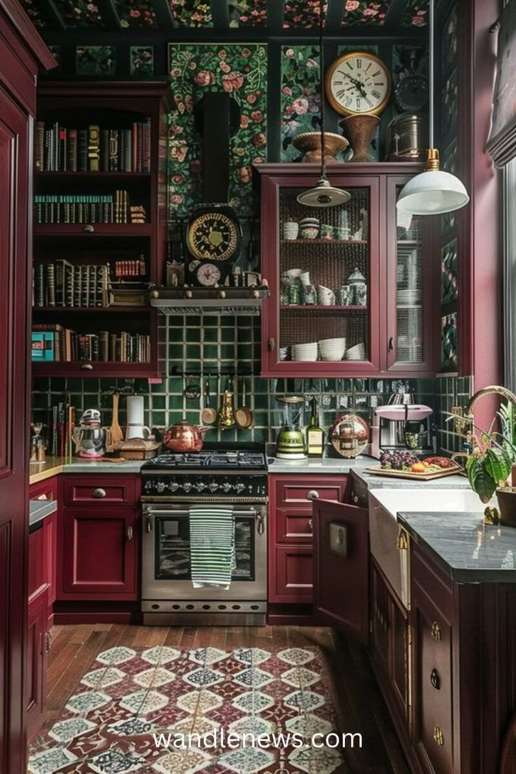 a kitchen with red cabinets and floral wallpaper on the walls, along with an ornate rug