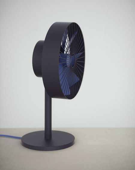 a blue fan sitting on top of a table next to a black stand with a cord