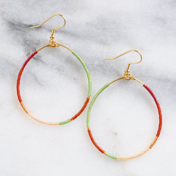 You asked for bigger beaded hoops and Libby & Smee answered! These dangly seed bead hoop earrings are the pieces you'll grab every day when you want a little something fun without a lot of fuss. Bonus: They look great dressed up or super casual. It's no surprise that they've become the Libby & Smee cult favorite. beaded hoops with tiny glass seed beads available in two large sizes: BIG, a teardrop shape approximately 1.75 inches wide and 2.75 inches long, or BIGGER, a circle shape 2.25 i Seed Bead Hoop Earrings, Bead Hoop Earrings, Beads Style, Muted Green, Plastic Earrings, Jackson Hole Wyoming, Earring Cards, Beading Wire, Beaded Hoop Earrings