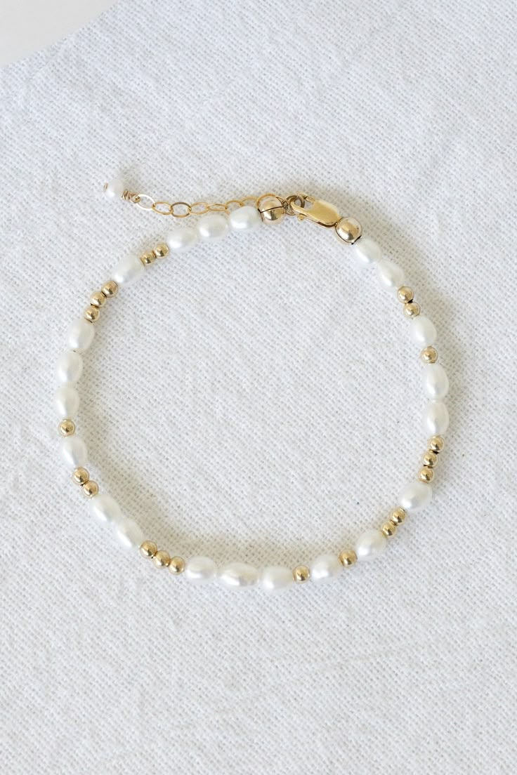 14k gold filled bracelet with 4mm-6mm freshwater pearls and 2.5mm gold filled beads Comes with an attached 1" extender chain! If you would like a different length that is not listed, please contact us for a custom order! Paired with our Mona Bracelet! Cheap Beaded Chain Bracelet For Women, Luxury Dainty Beaded Bracelets With Round Beads, Cheap Dainty Beaded Friendship Bracelets, Trendy Cheap Beaded Bracelets With Adjustable Chain, Cheap Minimalist Beaded Bracelets For Everyday Wear, Cheap Dainty Beaded Jubilee Bracelet, Elegant Cheap Beaded Bracelets, Cheap Everyday Summer Bracelets, Affordable White Beaded Bracelets With Gold Beads