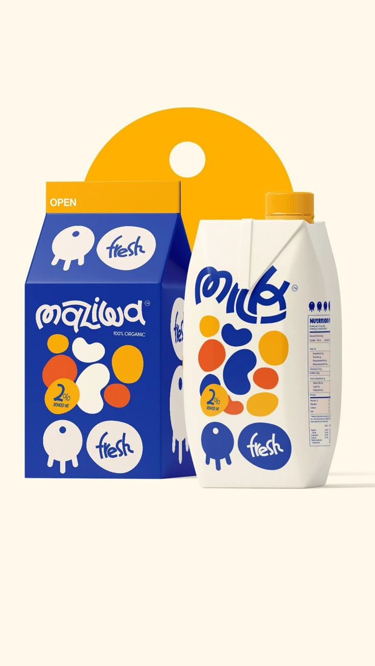 two boxes of milk sitting next to each other on a white surface with an orange circle in the background