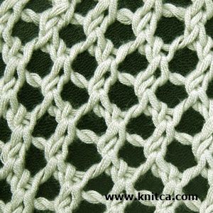 close up view of the white knitted fabric with wavy lines and knots on it