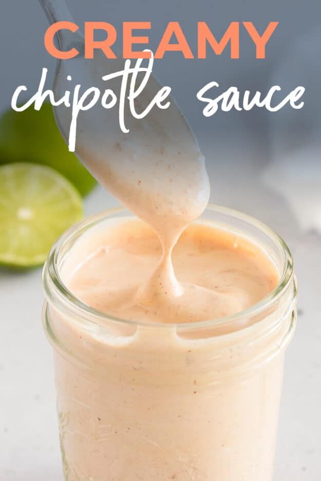 creamy chipotle sauce in a glass jar with a spoon sticking out of it