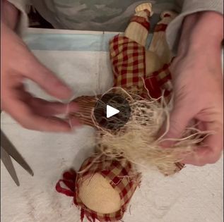 someone is making a scarecrow doll out of fabric