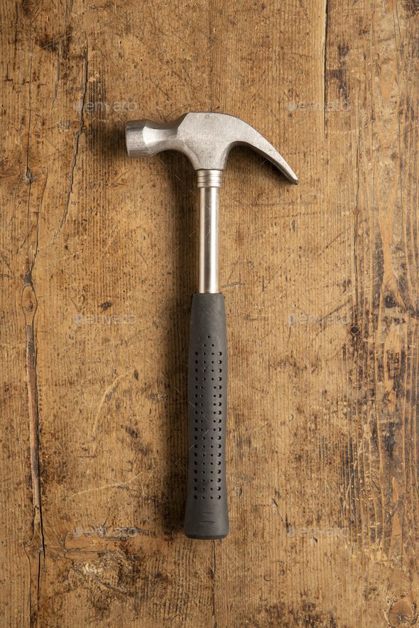 a hammer on top of a wooden table