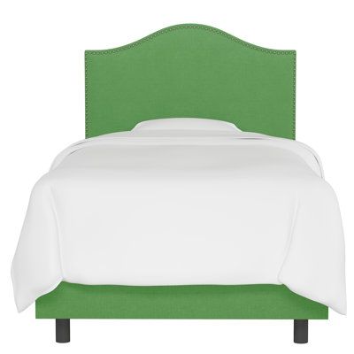 a bed with a green headboard and white sheets on it's side, against a white background