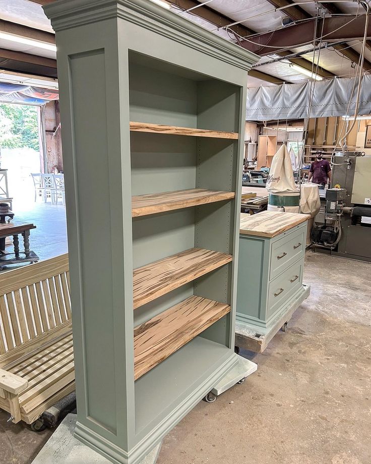 the shelves are made out of wood and painted green