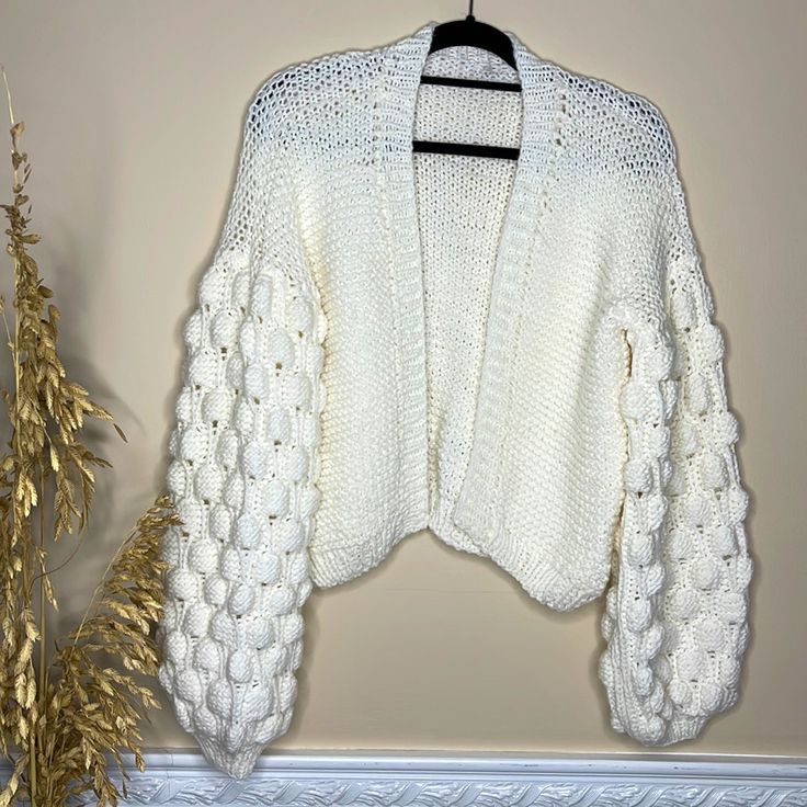 Chunky White Hand Knitted Cardigan With Bubble Sleeves Size: M Composition: Wool/Acrylic Blend Care Instructions: Machine Wash On Cold On Gentle Cycle, Dry Flat, Reshape! Condition: Brand New Cardigan Knitted By Me Bundle It With Another Items From My Closet And Receive 20% Discount On Entire Purchase! Always Open To Reasonable Offers! Trendy Textured Knit Acrylic Cardigan, Chic White Knit Cardigan, Fitted Chunky Knit Acrylic Sweater, Cozy Textured Knit Cardigan, Cozy Fitted Acrylic Cardigan, Cozy Textured Knit Acrylic Cardigan, One Size Knit Cardigan, One Size Knit Cardigan With Knitting Details, White Knit Acrylic Sweater