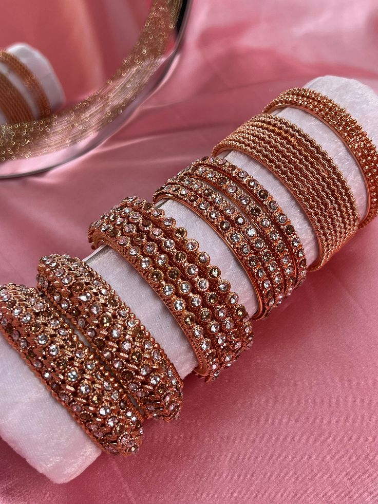 Create new unique mini or mid bangle sets for every occasion with our individual and statement pieces! Colour Collection includes 4 x Rose gold bangles 8 x Ridges rose gold bangles 4 x Rhinestone silver bangles 4 x High edge rhinestone bangles 2 x Thick kada rhienstone bangles  Also available in Gold and Silver ! Ready to ship 📦 (Roll not included) Hand Set Rose Gold Jewelry For Celebration, Festive Rose Gold Bangle Jewelry, Rose Gold Hand Set Bangle, Rose Gold Jewelry For Festivals And Celebrations, Rose Gold Jewelry For Celebrations And Festivals, Rose Gold Hand Set Bracelets For Party, Elegant Rose Gold Bracelets For Festive Occasions, Rose Gold Jewelry For Festivals Gift, Rose Gold Jewelry For Festivals And Gifts